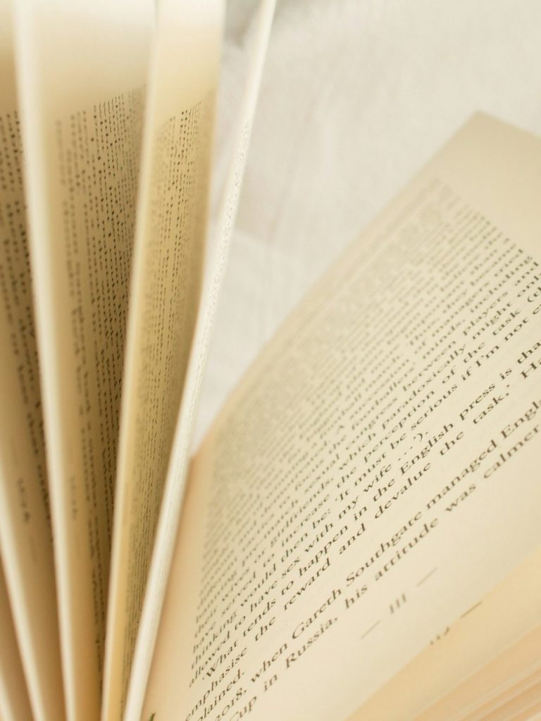 Open book with pages fanned, showing text on the right-hand side.